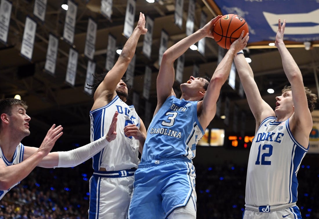 Mar 9, 2024; Durham, North Carolina, USA; North Carolina Tar Heels guard Cormac Ryan (3) shoots over  Duke Blue Devils guard Jared McCain (0) during the first half at Cameron Indoor Stadium. Mandatory Credit: Rob Kinnan-USA TODAY Sports