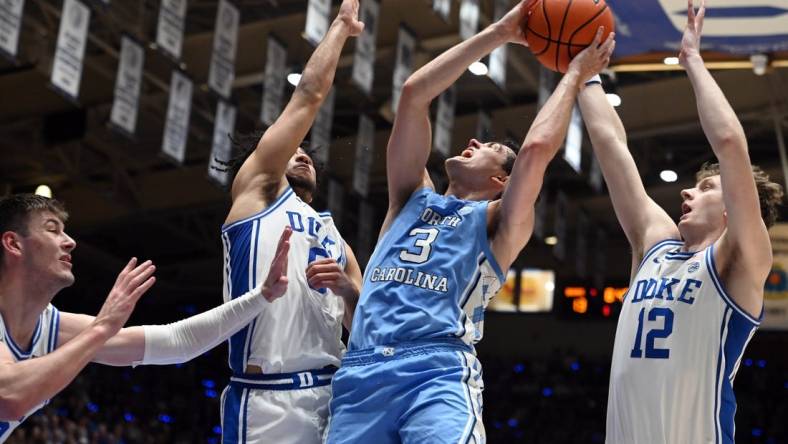 Mar 9, 2024; Durham, North Carolina, USA; North Carolina Tar Heels guard Cormac Ryan (3) shoots over  Duke Blue Devils guard Jared McCain (0) during the first half at Cameron Indoor Stadium. Mandatory Credit: Rob Kinnan-USA TODAY Sports