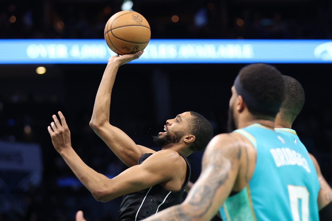 Mar 9, 2024; Charlotte, North Carolina, USA;  Brooklyn Nets forward Mikal Bridges (1) makes a shot against the Charlotte Hornets during the first quarter at Spectrum Center. Mandatory Credit: Cory Knowlton-USA TODAY Sports