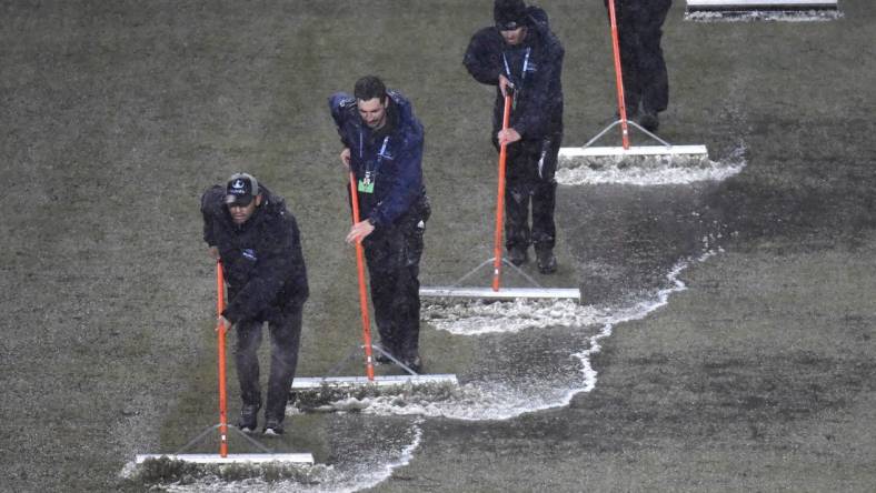 Mar 9, 2024; Philadelphia, Pennsylvania, USA; Members of the stadium grounds crew squeegee the field during a rain delay in the match between the Seattle Sounders FC and the Philadelphia Union at Subaru Park. Mandatory Credit: Eric Hartline-USA TODAY Sports