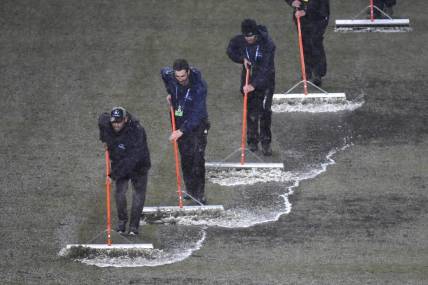 Mar 9, 2024; Philadelphia, Pennsylvania, USA; Members of the stadium grounds crew squeegee the field during a rain delay in the match between the Seattle Sounders FC and the Philadelphia Union at Subaru Park. Mandatory Credit: Eric Hartline-USA TODAY Sports