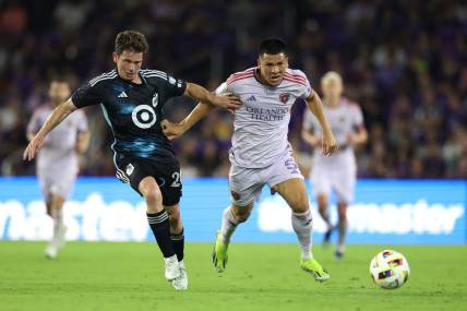 Mar 9, 2024; Orlando, Florida, USA; Orlando City midfielder Cesar Araujo (5) battles for the ball with Minnesota United midfielder Wil Trapp (20) during the first half at Inter & Co Stadium. Mandatory Credit: Nathan Ray Seebeck-USA TODAY Sports