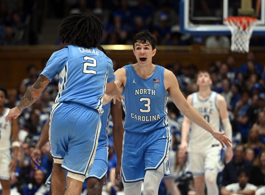 Mar 9, 2024; Durham, North Carolina, USA; North Carolina Tar Heels guard Cormac Ryan (3) reacts to a basket by  guard Elliot Cadeau (2) during the second half against the Duke Blue Devils at Cameron Indoor Stadium. The Tar Heels won 84-79. Mandatory Credit: Rob Kinnan-USA TODAY Sports