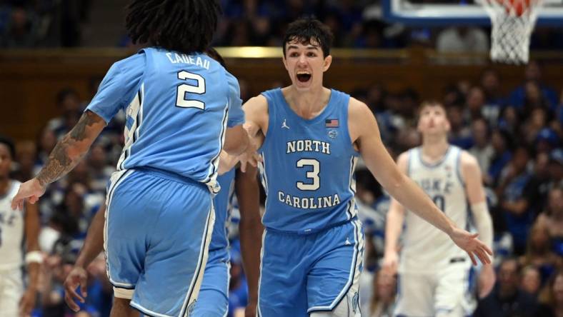 Mar 9, 2024; Durham, North Carolina, USA; North Carolina Tar Heels guard Cormac Ryan (3) reacts to a basket by  guard Elliot Cadeau (2) during the second half against the Duke Blue Devils at Cameron Indoor Stadium. The Tar Heels won 84-79. Mandatory Credit: Rob Kinnan-USA TODAY Sports