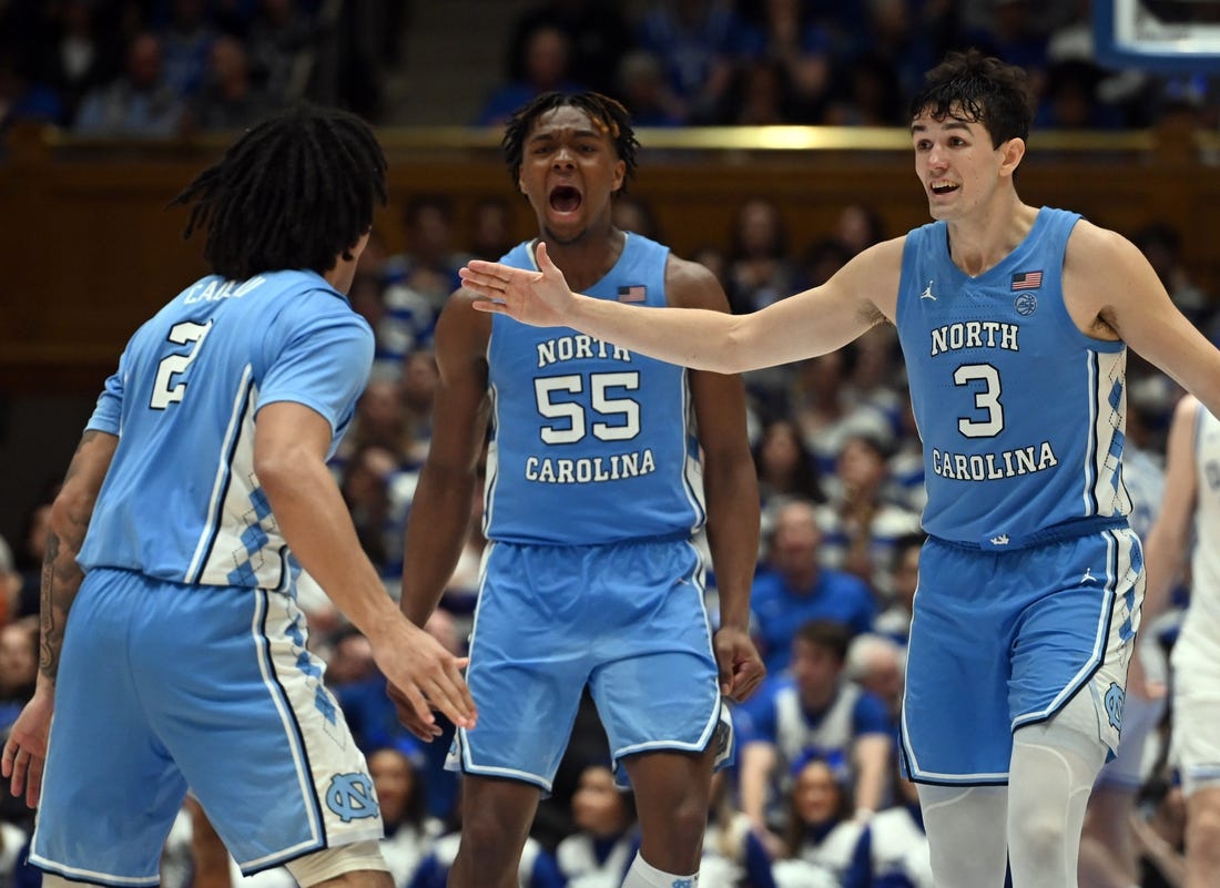 Mar 9, 2024; Durham, North Carolina, USA; North Carolina Tar Heels guard Cormac Ryan (3) and forward Harrison Ingram (55) react to a basket by guard Elliot Cadeau (2) during the second half against the Duke Blue Devils at Cameron Indoor Stadium. The Tar Heels won 84-79. Mandatory Credit: Rob Kinnan-USA TODAY Sports