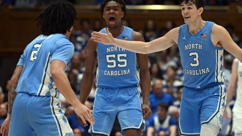 Mar 9, 2024; Durham, North Carolina, USA; North Carolina Tar Heels guard Cormac Ryan (3) and forward Harrison Ingram (55) react to a basket by guard Elliot Cadeau (2) during the second half against the Duke Blue Devils at Cameron Indoor Stadium. The Tar Heels won 84-79. Mandatory Credit: Rob Kinnan-USA TODAY Sports