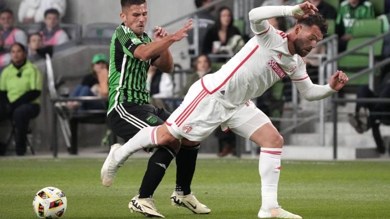 Mar 9, 2024; Austin, Texas, USA; Austin FC forward Diego Rubio (14) and St. Louis CITY SC midfielder Eduard Loewen (10) battle for the ball during the first half at Q2 Stadium. Mandatory Credit: Scott Wachter-USA TODAY Sports