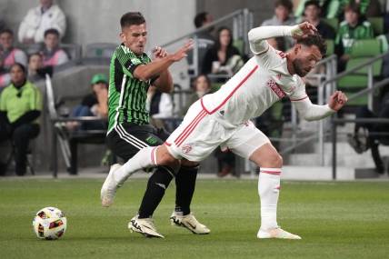 Mar 9, 2024; Austin, Texas, USA; Austin FC forward Diego Rubio (14) and St. Louis CITY SC midfielder Eduard Loewen (10) battle for the ball during the first half at Q2 Stadium. Mandatory Credit: Scott Wachter-USA TODAY Sports