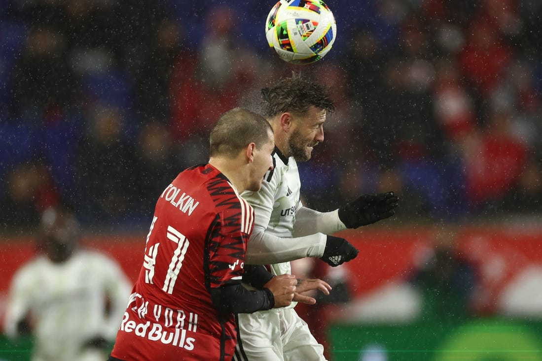 Mar 9, 2024; Harrison, New Jersey, USA; FC Dallas forward Paul Arriola (7) and New York Red Bulls defender John Tolkin (47) jump for a header in the second half at Red Bull Arena. Mandatory Credit: Vincent Carchietta-USA TODAY Sports