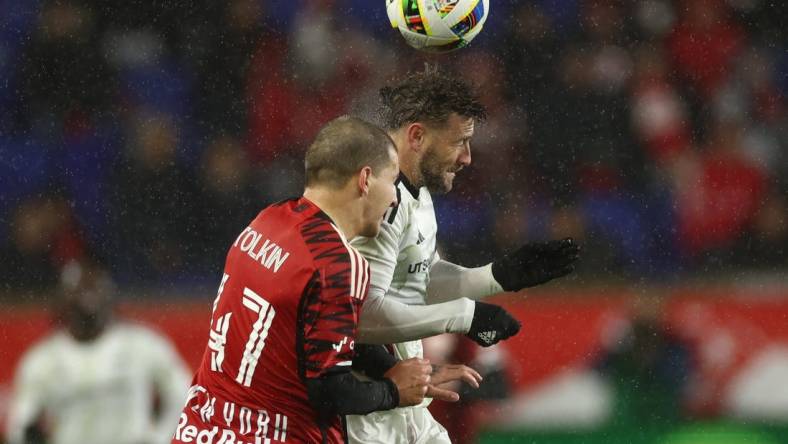 Mar 9, 2024; Harrison, New Jersey, USA; FC Dallas forward Paul Arriola (7) and New York Red Bulls defender John Tolkin (47) jump for a header in the second half at Red Bull Arena. Mandatory Credit: Vincent Carchietta-USA TODAY Sports