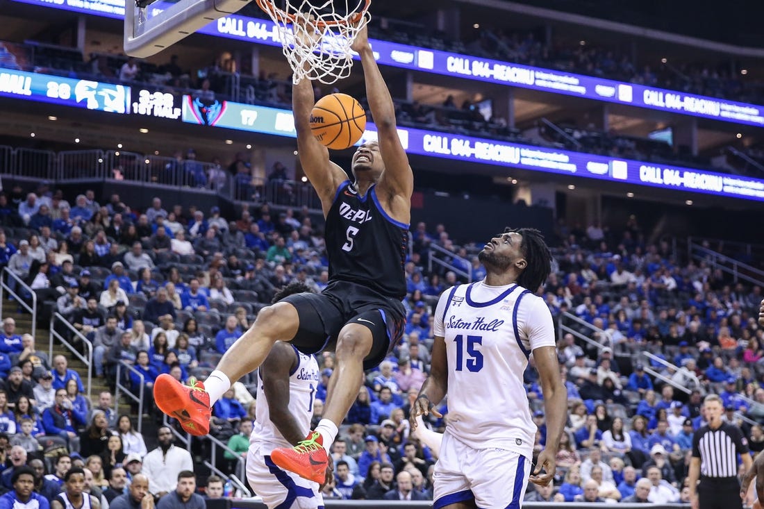 Mar 9, 2024; Newark, New Jersey, USA;  DePaul Blue Demons center Churchill Abass (5) dunks past Seton Hall Pirates center Jaden Bediako (15) in the first half at Prudential Center. Mandatory Credit: Wendell Cruz-USA TODAY Sports