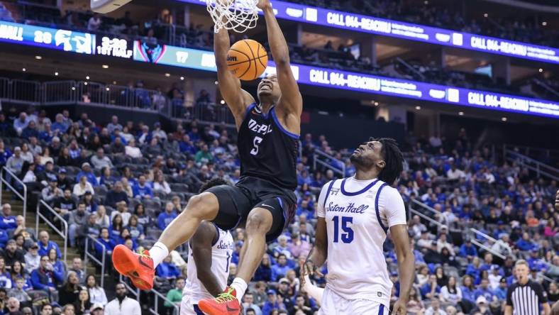 Mar 9, 2024; Newark, New Jersey, USA;  DePaul Blue Demons center Churchill Abass (5) dunks past Seton Hall Pirates center Jaden Bediako (15) in the first half at Prudential Center. Mandatory Credit: Wendell Cruz-USA TODAY Sports