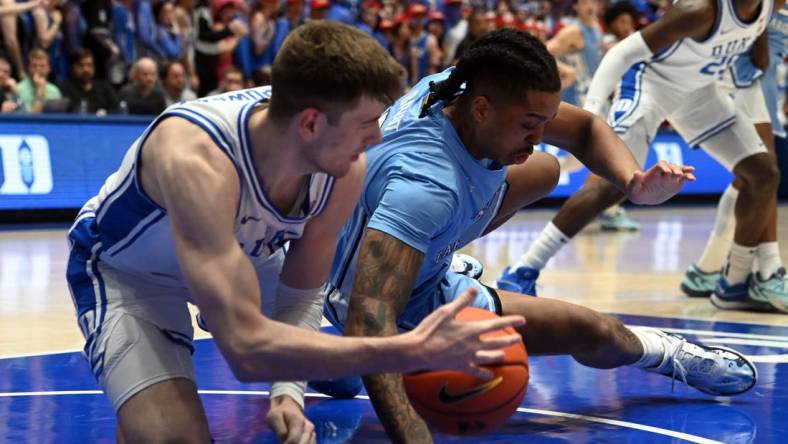 Mar 9, 2024; Durham, North Carolina, USA; North Carolina Tar Heels forward Armando Bacot (5) grabs a loose ball from Duke Blue Devils center Kyle Filipowski (30) during the first half at Cameron Indoor Stadium. Mandatory Credit: Rob Kinnan-USA TODAY Sports