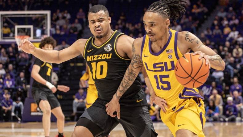 Mar 9, 2024; Baton Rouge, Louisiana, USA; LSU Tigers forward Tyrell Ward (15) brings the ball up court against Missouri Tigers guard Nick Honor (10) during the first half at Pete Maravich Assembly Center. Mandatory Credit: Stephen Lew-USA TODAY Sports