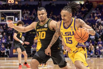 Mar 9, 2024; Baton Rouge, Louisiana, USA; LSU Tigers forward Tyrell Ward (15) brings the ball up court against Missouri Tigers guard Nick Honor (10) during the first half at Pete Maravich Assembly Center. Mandatory Credit: Stephen Lew-USA TODAY Sports