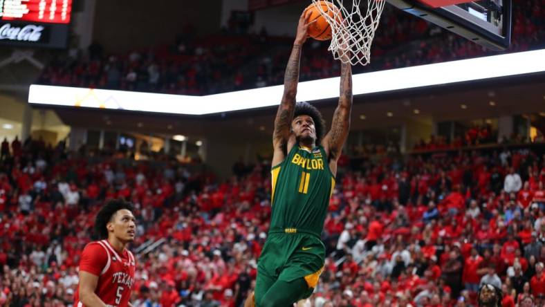 Mar 9, 2024; Lubbock, Texas, USA;  Baylor Bears forward Jalen Bridges (11) dunks the ball against Texas Tech Red Raiders guard Darrion Williams (5) in the second half at United Supermarkets Arena. Mandatory Credit: Michael C. Johnson-USA TODAY Sports