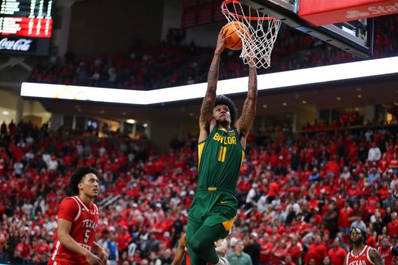 Mar 9, 2024; Lubbock, Texas, USA;  Baylor Bears forward Jalen Bridges (11) dunks the ball against Texas Tech Red Raiders guard Darrion Williams (5) in the second half at United Supermarkets Arena. Mandatory Credit: Michael C. Johnson-USA TODAY Sports
