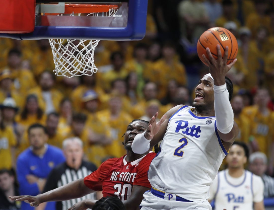 Mar 9, 2024; Pittsburgh, Pennsylvania, USA;  Pittsburgh Panthers forward Blake Hinson (2) goes to the basket past North Carolina State Wolfpack forward DJ Burns Jr. (30) during the second half at the Petersen Events Center. The Panthers won 81-73. Mandatory Credit: Charles LeClaire-USA TODAY Sports