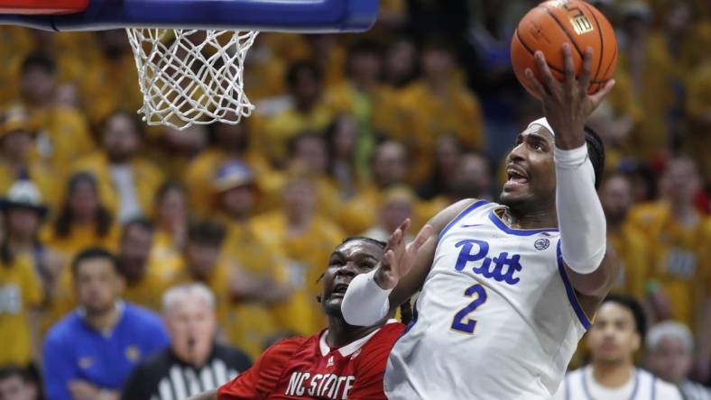 Mar 9, 2024; Pittsburgh, Pennsylvania, USA;  Pittsburgh Panthers forward Blake Hinson (2) goes to the basket past North Carolina State Wolfpack forward DJ Burns Jr. (30) during the second half at the Petersen Events Center. The Panthers won 81-73. Mandatory Credit: Charles LeClaire-USA TODAY Sports