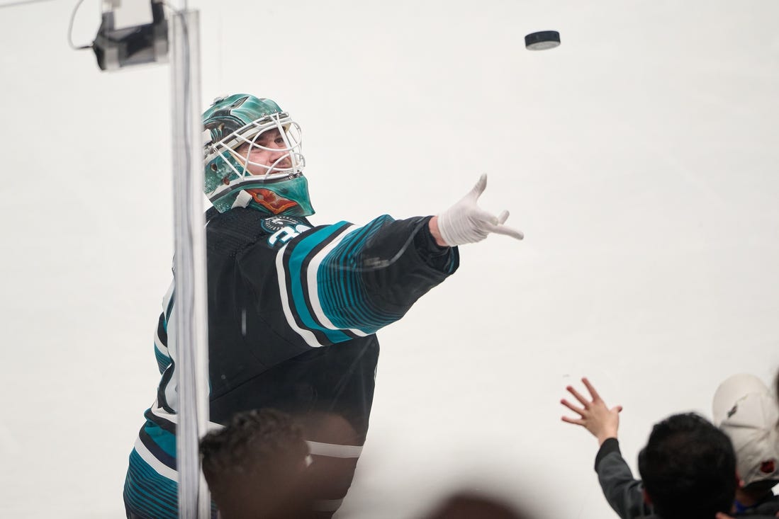 Mar 9, 2024; San Jose, California, USA; San Jose Sharks goaltender Magnus Chrona (30) tosses a puck to a fan after defeating the Ottawa Senators after the game at SAP Center at San Jose. Mandatory Credit: Robert Edwards-USA TODAY Sports