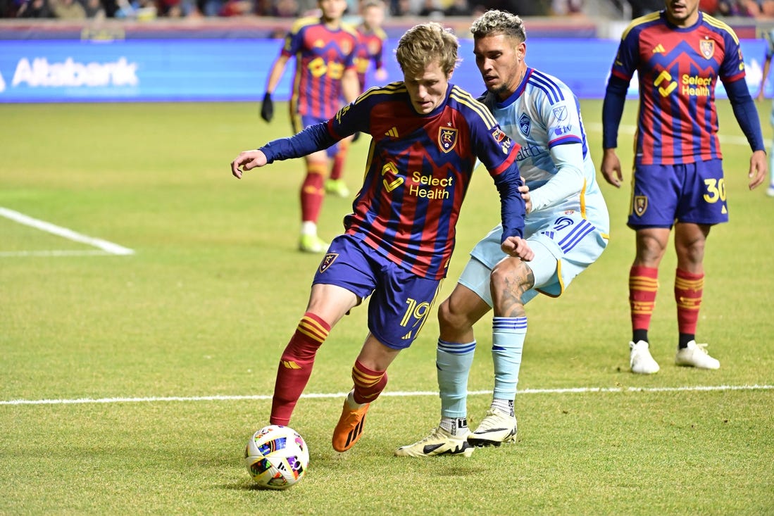 Mar 9, 2024; Sandy, Utah, USA; Real Salt Lake midfielder Bode Hidalgo (19) dribbles the ball against Colorado Rapids forward Rafael Navarro (9) during the first half at America First Field. Mandatory Credit: Christopher Creveling-USA TODAY Sports