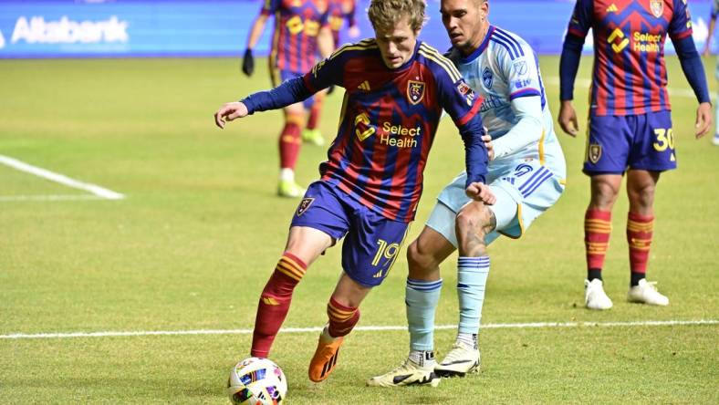 Mar 9, 2024; Sandy, Utah, USA; Real Salt Lake midfielder Bode Hidalgo (19) dribbles the ball against Colorado Rapids forward Rafael Navarro (9) during the first half at America First Field. Mandatory Credit: Christopher Creveling-USA TODAY Sports