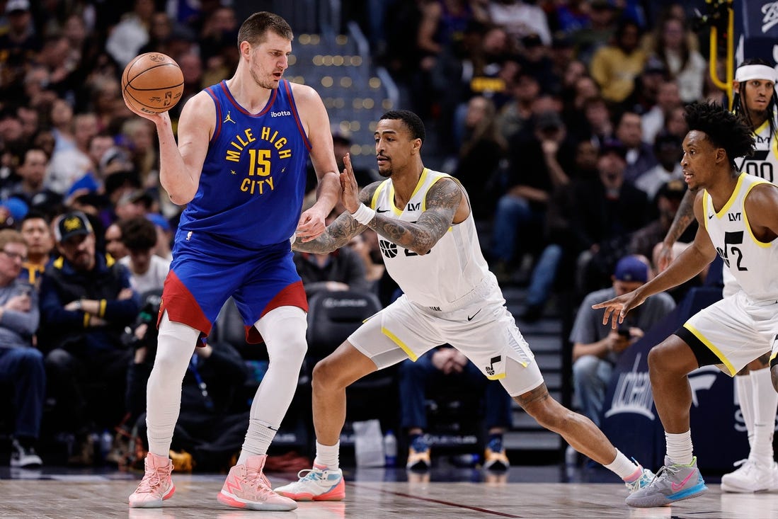 Mar 9, 2024; Denver, Colorado, USA; Denver Nuggets center Nikola Jokic (15) looks to pass the ball as Utah Jazz forward John Collins (20) guards in the second quarter at Ball Arena. Mandatory Credit: Isaiah J. Downing-USA TODAY Sports