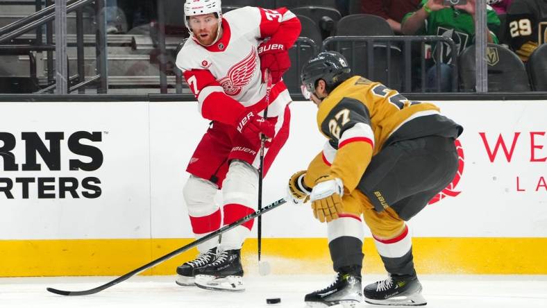 Mar 9, 2024; Las Vegas, Nevada, USA; Detroit Red Wings left wing J.T. Compher (37) makes a pass in front of Vegas Golden Knights defenseman Shea Theodore (27) during the first period at T-Mobile Arena. Mandatory Credit: Stephen R. Sylvanie-USA TODAY Sports