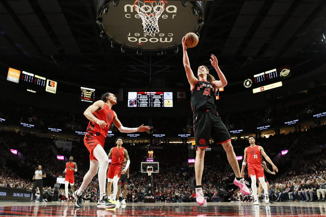 Mar 9, 2024; Portland, Oregon, USA; Toronto Raptors power forward Kelly Olynyk (41) shoots the ball as Portland Trail Blazers guard Dalano Banton (5) looks on during the first half at Moda Center. Mandatory Credit: Soobum Im-USA TODAY Sports