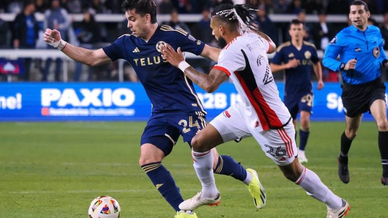 Mar 9, 2024; San Jose, California, USA; Vancouver Whitecaps FC forward Brian White (24) and San Jose Earthquakes defender Rodrigues (26) battle for the ball during the first half at PayPal Park. Mandatory Credit: Kelley L Cox-USA TODAY Sports