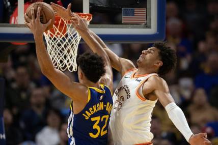 Mar 9, 2024; San Francisco, California, USA; Golden State Warriors forward Trayce Jackson-Davis (32) manages to get a shot around the defense of San Antonio Spurs forward Dominick Barlow (26) during the third quarter at Chase Center. Mandatory Credit: D. Ross Cameron-USA TODAY Sports