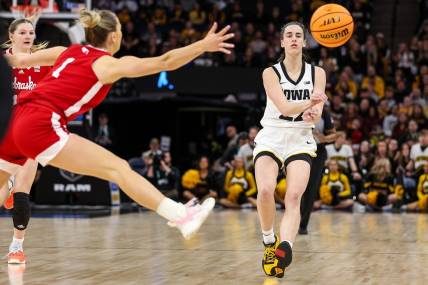 Mar 10, 2024; Minneapolis, MN, USA; Iowa Hawkeyes guard Caitlin Clark (22) passes as Nebraska Cornhuskers guard Jaz Shelley (1) defends during the first half at Target Center. Mandatory Credit: Matt Krohn-USA TODAY Sports