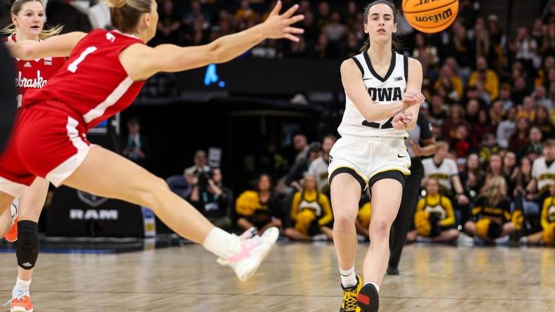 Mar 10, 2024; Minneapolis, MN, USA; Iowa Hawkeyes guard Caitlin Clark (22) passes as Nebraska Cornhuskers guard Jaz Shelley (1) defends during the first half at Target Center. Mandatory Credit: Matt Krohn-USA TODAY Sports