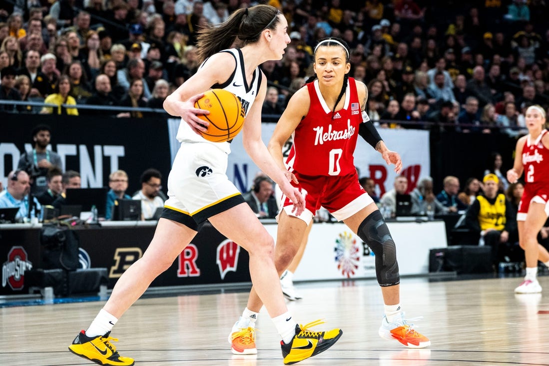 Iowa guard Caitlin Clark (22) dribbles the ball against Nebraska guard Darian White during the Big Ten Tournament championship game at the Target Center on Sunday, March 10, 2024, in Minneapolis, Minn.