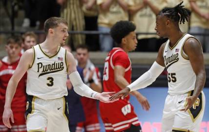 Purdue Boilermakers guard Braden Smith (3) high-fives Purdue Boilermakers guard Lance Jones (55) during the NCAA men's basketball game against the Wisconsin Badgers, Sunday, March 10, 2024, at Mackey Arena in West Lafayette, Ind.