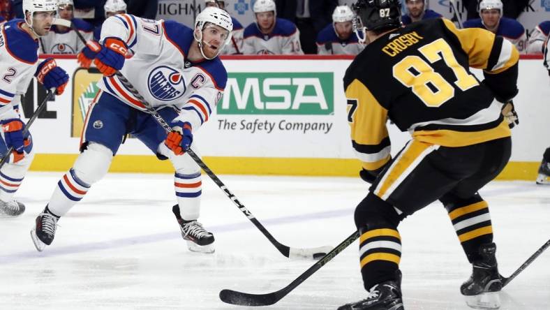 Mar 10, 2024; Pittsburgh, Pennsylvania, USA;  Edmonton Oilers center Connor McDavid (97) skates with the puck as Pittsburgh Penguins Pittsburgh Penguins center Sidney Crosby (87) defends during the second period at PPG Paints Arena. Mandatory Credit: Charles LeClaire-USA TODAY Sports