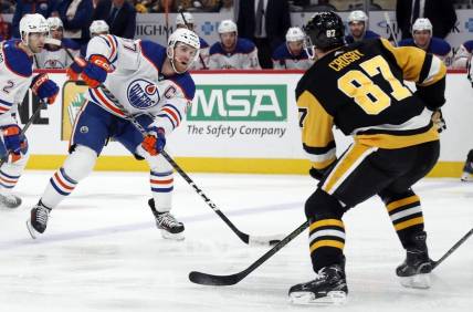Mar 10, 2024; Pittsburgh, Pennsylvania, USA;  Edmonton Oilers center Connor McDavid (97) skates with the puck as Pittsburgh Penguins Pittsburgh Penguins center Sidney Crosby (87) defends during the second period at PPG Paints Arena. Mandatory Credit: Charles LeClaire-USA TODAY Sports