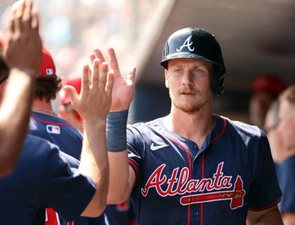 Mar 10, 2024; Tampa, Florida, USA;Atlanta Braves catcher Sean Murphy (12) is congratulated in the dugout after he scored during the first inning against the New York Yankees at George M. Steinbrenner Field. Mandatory Credit: Kim Klement Neitzel-USA TODAY Sports