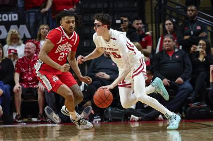 Mar 10, 2024; Piscataway, New Jersey, USA;Rutgers Scarlet Knights guard Gavin Griffiths (10) dribbles against Ohio State Buckeyes forward Devin Royal (21) during the first half at Jersey Mike's Arena. Mandatory Credit: Vincent Carchietta-USA TODAY Sports