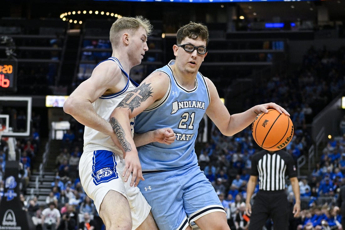 Mar 10, 2024; St. Louis, MO, USA;  Indiana State Sycamores center Robbie Avila (21) drives to the basket as Drake Bulldogs forward Nate Ferguson (24) defends during the first half of the Missouri Valley Conference Tournament Championship game at Enterprise Center. Mandatory Credit: Jeff Curry-USA TODAY Sports