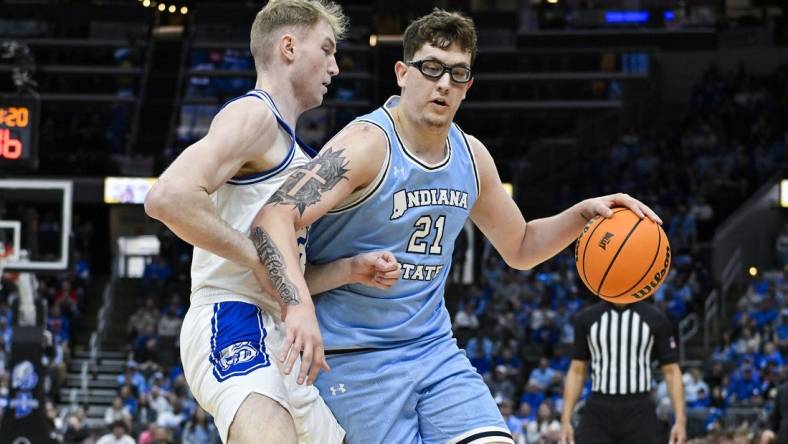 Mar 10, 2024; St. Louis, MO, USA;  Indiana State Sycamores center Robbie Avila (21) drives to the basket as Drake Bulldogs forward Nate Ferguson (24) defends during the first half of the Missouri Valley Conference Tournament Championship game at Enterprise Center. Mandatory Credit: Jeff Curry-USA TODAY Sports