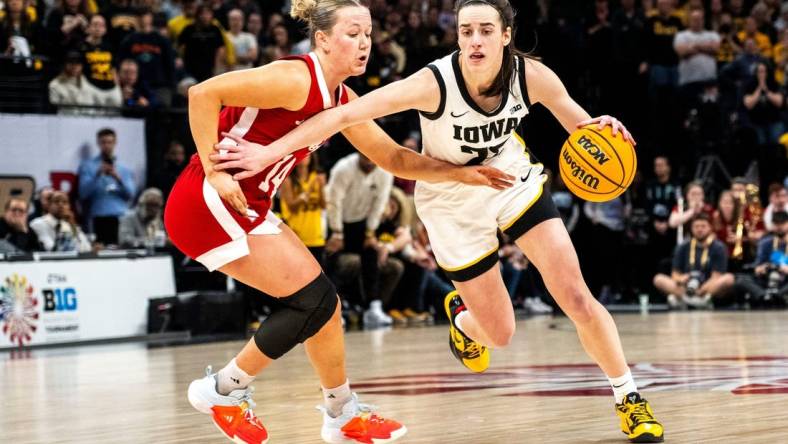 Iowa guard Caitlin Clark (22) drives to the basket against Nebraska guard Callin Hake during the Big Ten Tournament championship game at the Target Center on Sunday, March 10, 2024, in Minneapolis, Minn.