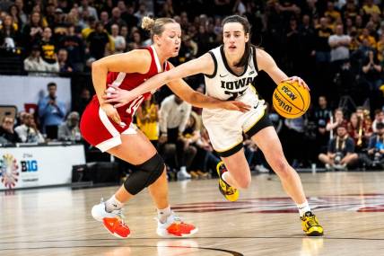 Iowa guard Caitlin Clark (22) drives to the basket against Nebraska guard Callin Hake during the Big Ten Tournament championship game at the Target Center on Sunday, March 10, 2024, in Minneapolis, Minn.