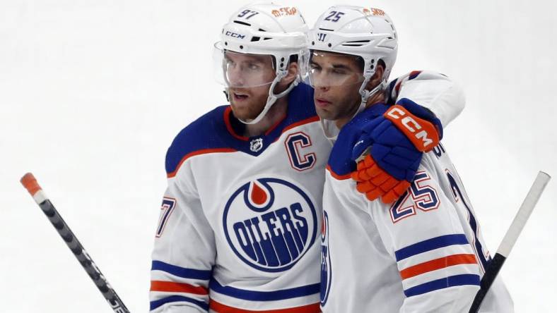 Mar 10, 2024; Pittsburgh, Pennsylvania, USA;  Edmonton Oilers center Connor McDavid (left) congratulates  defenseman Darnell Nurse (25) after Nurse scored a goal against the Pittsburgh Penguins during the third period at PPG Paints Arena. The Oilers won 4-0. Mandatory Credit: Charles LeClaire-USA TODAY Sports