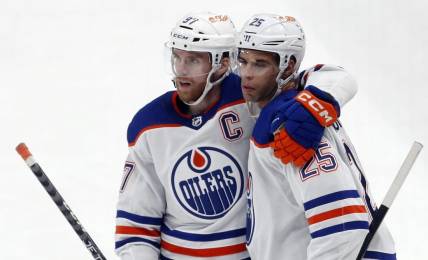 Mar 10, 2024; Pittsburgh, Pennsylvania, USA;  Edmonton Oilers center Connor McDavid (left) congratulates  defenseman Darnell Nurse (25) after Nurse scored a goal against the Pittsburgh Penguins during the third period at PPG Paints Arena. The Oilers won 4-0. Mandatory Credit: Charles LeClaire-USA TODAY Sports
