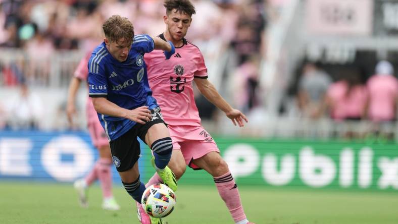 Mar 10, 2024; Fort Lauderdale, Florida, USA; CF Montreal midfielder Bryce Duke (10) dribbles away from Inter Miami CF defender Noah Allen (32) during the first half at Chase Stadium. Mandatory Credit: Nathan Ray Seebeck-USA TODAY Sports