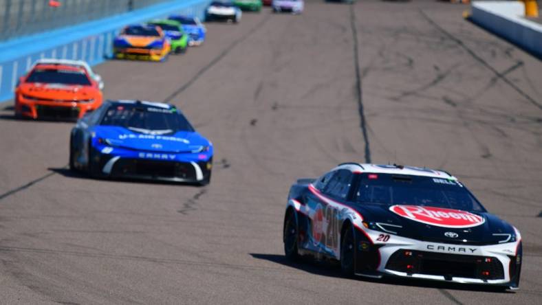 Mar 10, 2024; Avondale, Arizona, USA; NASCAR Cup Series driver Christopher Bell (20) leads a group during the Shriners Children’s 500 at Phoenix Raceway. Mandatory Credit: Gary A. Vasquez-USA TODAY Sports
