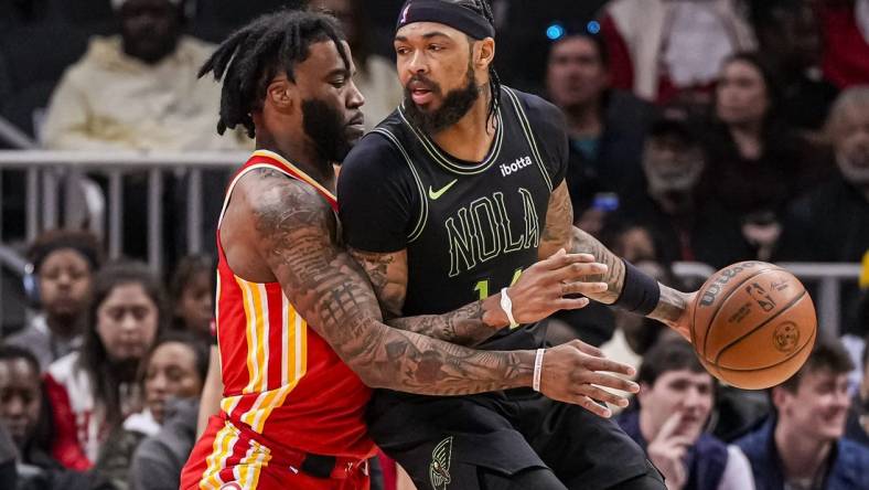 Mar 10, 2024; Atlanta, Georgia, USA; New Orleans Pelicans forward Brandon Ingram (14) dribbles guarded by Atlanta Hawks forward Saddiq Bey (41) during the first half at State Farm Arena. Mandatory Credit: Dale Zanine-USA TODAY Sports