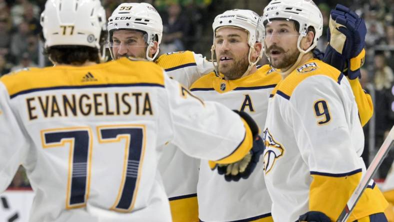 Mar 10, 2024; Saint Paul, Minnesota, USA;  Nashville Predators forward Ryan O'Reilly (90) celebrates his power play goal with defenseman Roman Josi (59) and forward Filip Forsberg (9) during the third period at Xcel Energy Center. Mandatory Credit: Nick Wosika-USA TODAY Sports