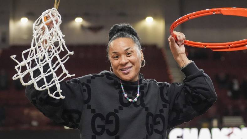 Mar 10, 2024; Greensville, SC, USA;  South Carolina Gamecocks head coach Dawn Staley cuts the net after winning the SEC championship over LSU Lady Tigers at Bon Secours Wellness Arena. Mandatory Credit: Jim Dedmon-USA TODAY Sports